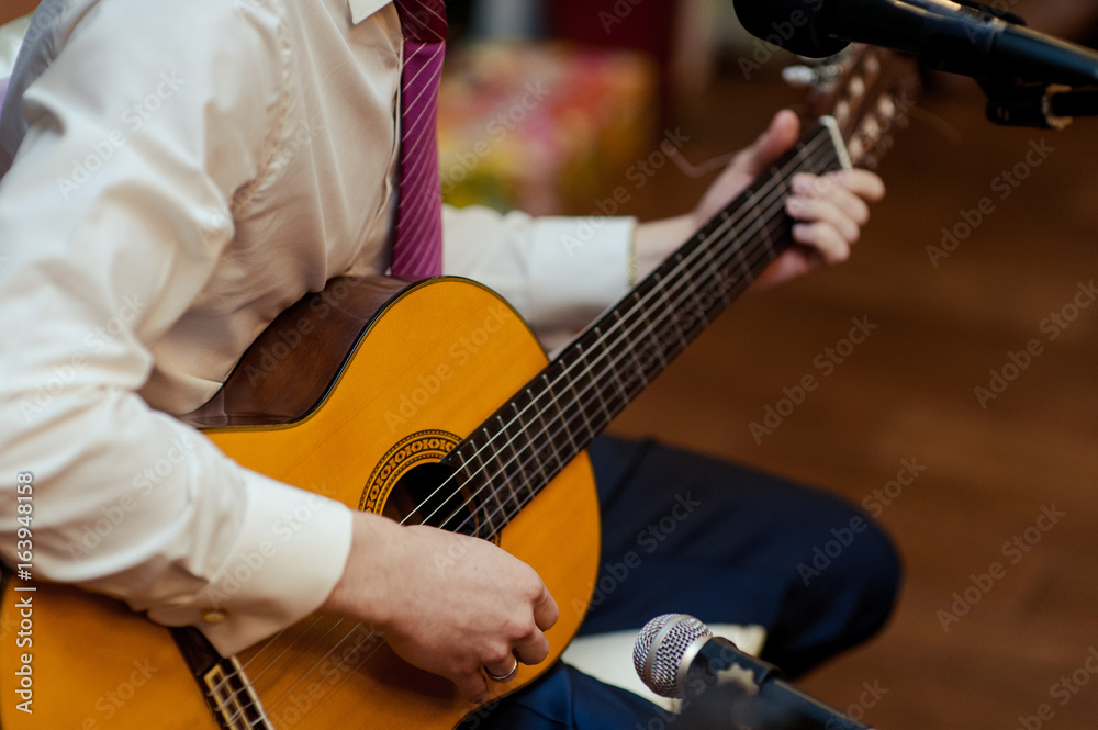 Fototapeta premium Handsome young men playing guitar
