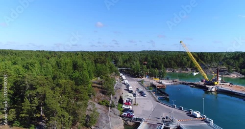 Car queue, Cinema 4k aerial view over two cable ferrys and a line of cars, heading to houtskar and kokar, on a sunny summer day, in the finnish archipelago photo