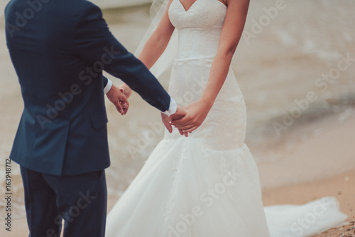 Holding hands. Closeup view of married couple holding hands © ViDi Studio