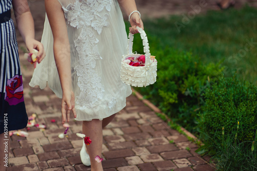 Little bridesmaid with a basket of rose petals