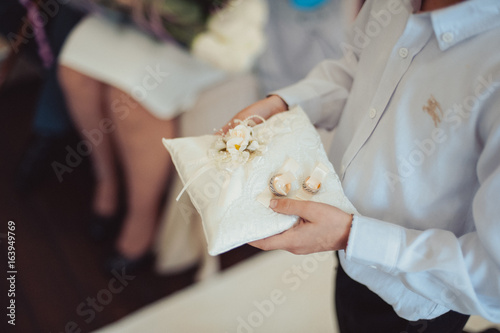 Canvas-taulu little girl or boy Carrying Wedding Ring On Cushion
