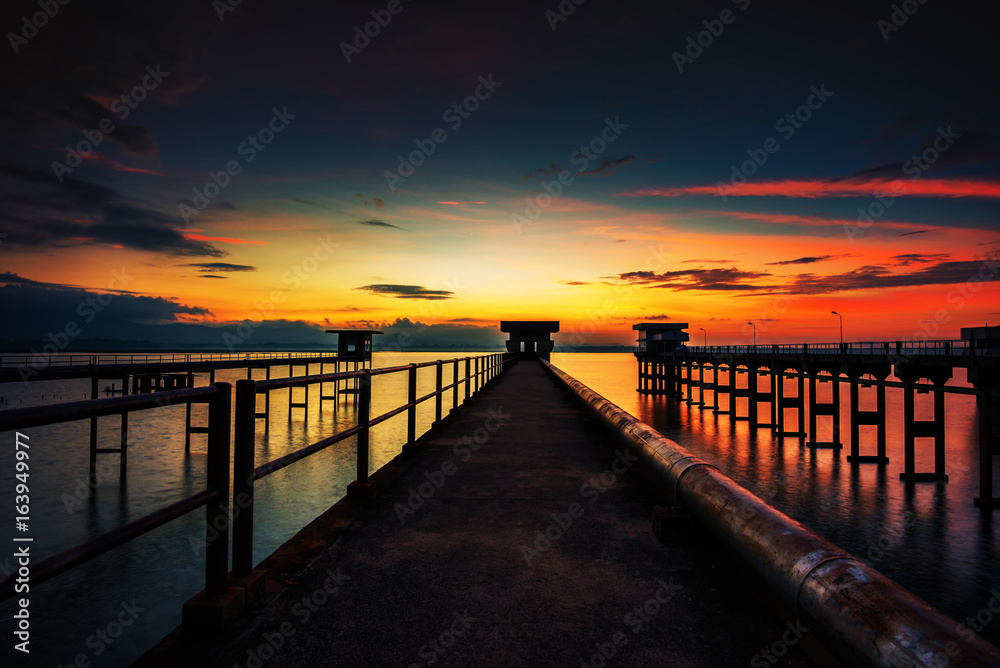 The sun reflected off the bridge that stretches into the sea.In Chonburi Thailand.