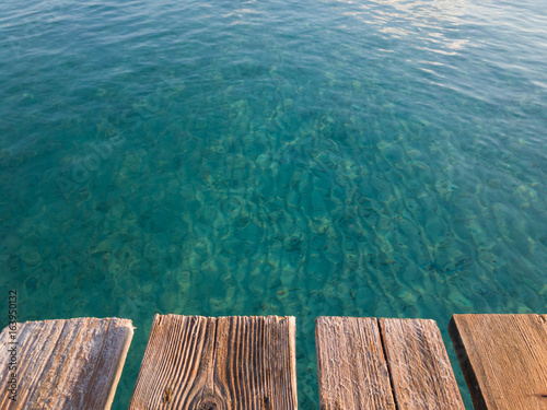Rustic wooden boards pier, summer vacation background © Pablo Lagarto