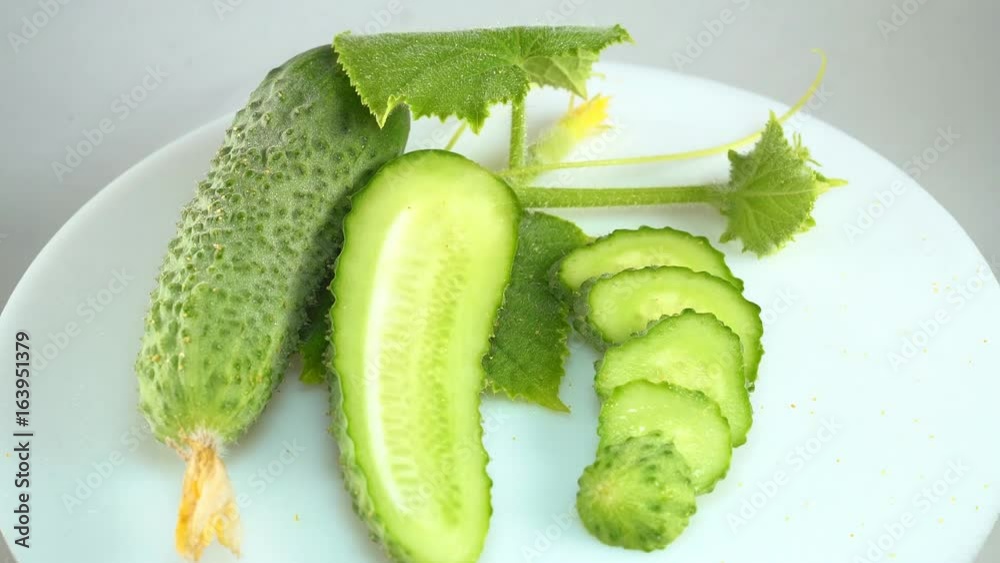Fresh cucumber on a white plate.