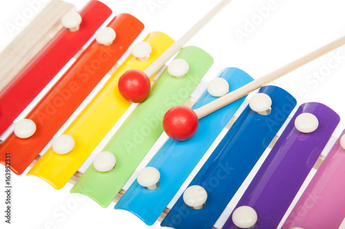 Rainbow colored toy xylophone, isolated on white