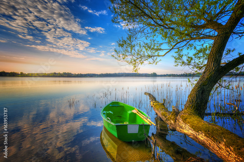 Rowing boat floating over the Lake Selment Wielki waters. Masuria, Poland.