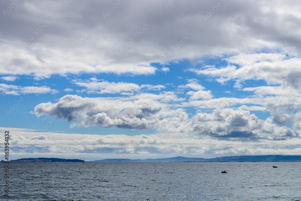 view of the ocean and a blue sky with clouds