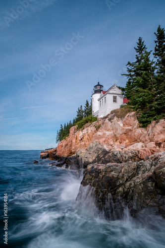 beautiful white lighthouse on a rocky promontory on the coast of northern Maine near Acadia National Park and Bar Harbor