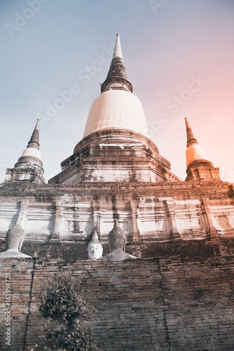 Ancient white buddha statues and ruined pagoda at Wat Yai Chai Mongkol in Ayutthaya historic attractions ,Thailand.