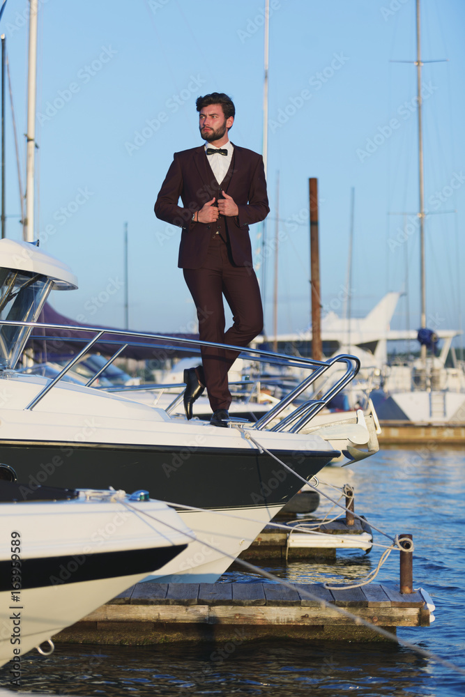 Young and handsome man on a sailing boat