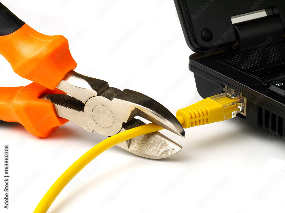 wire cutter cutting network cable from laptop on white background wire cutter cutting network cable from laptop on white background