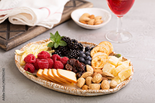 Cheese plate with nuts and berries