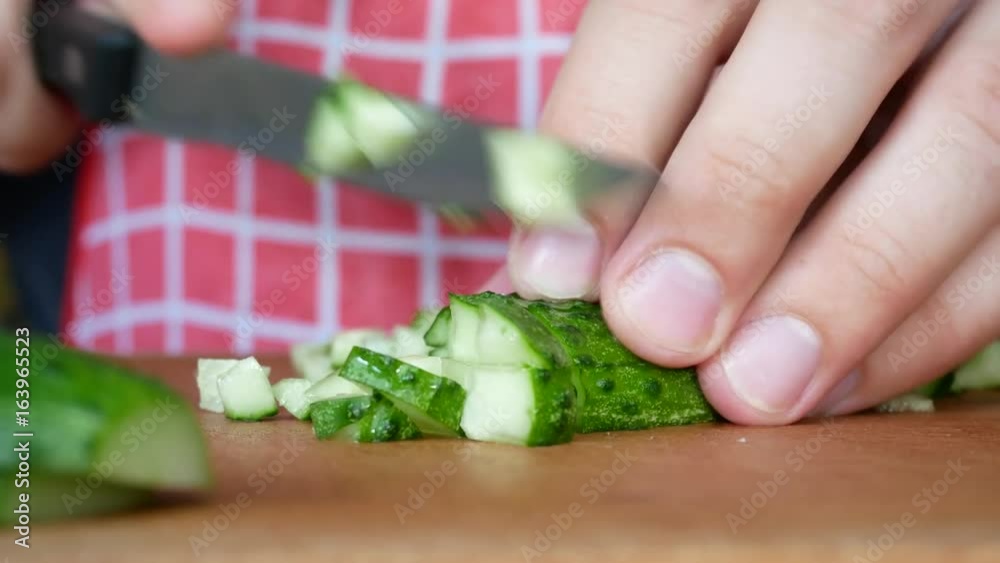Man Cutting Tasty Green Cucumber on Chopping Board With Knife. Cooking Salad in Home Kitchen. Chefcook are Chopping Slices Cucumber. Hands Sliced Cucumber In Vegan Salad. Diet And Healthy Food Man Cutting Tasty Green Cucumber on Chopping Board With Knife. Cooking Salad in Home Kitchen. Chefcook are Chopping Slices Cucumber. Hands Sliced Cucumber In Vegan Salad. Diet And Healthy Food