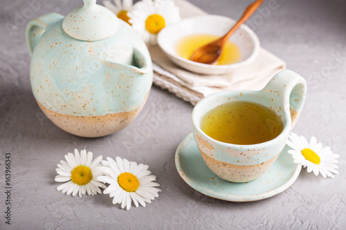 Fototapeta Naklejka Na Ścianę i Meble -  Camomille tea in handmade ceramic cup