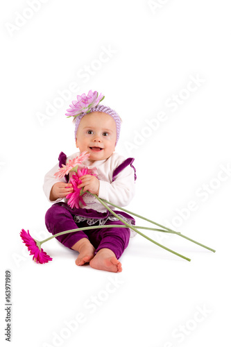 Cute little girl with flowers gerberas on white background