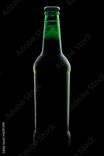 green bottle of beer, clipping path,on a black background, with brilliant edges and foam