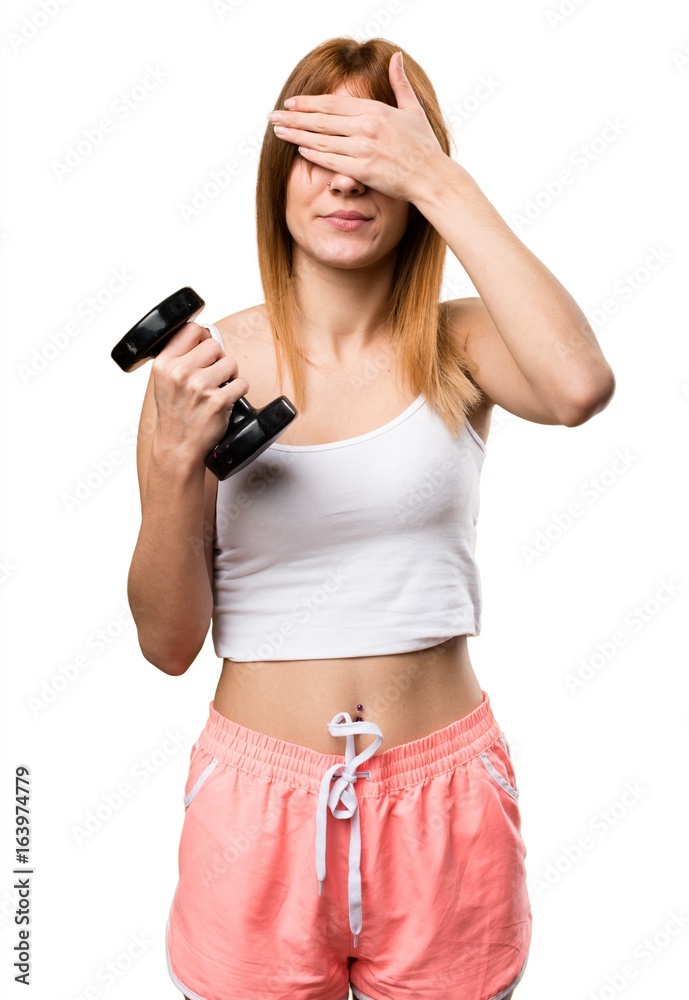 Beautiful sport woman with dumbbells covering her eyes Beautiful sport woman with dumbbells covering her eyes