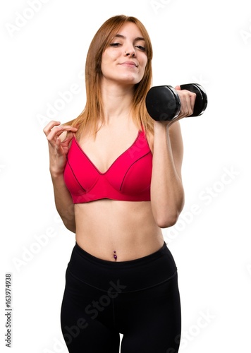 Beautiful sport woman with dumbbells proud of herself