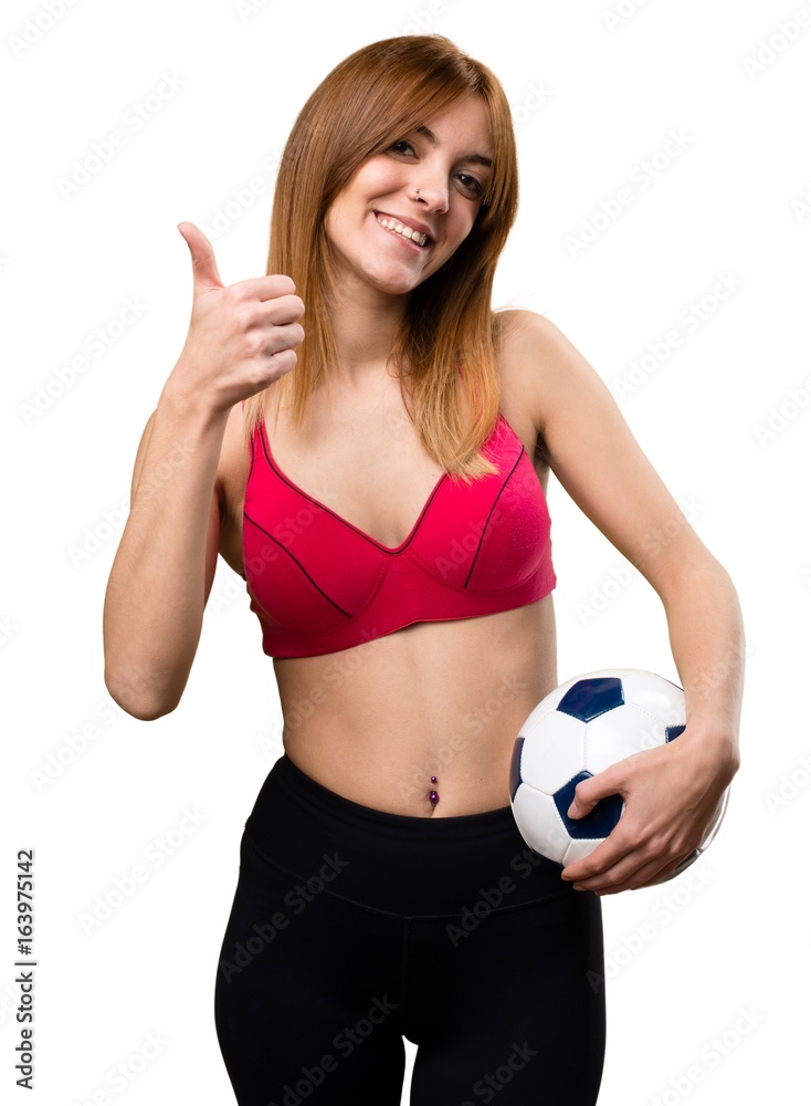Young sport woman holding a soccer ball Young sport woman holding a soccer ball