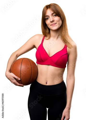 Young sport woman with ball of basketball
