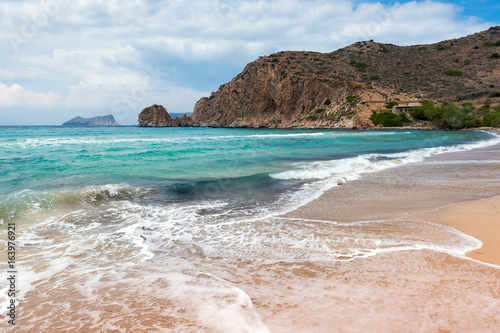 Plathiena, lovely beach with crystal blue waters on the northern side of Milos in Cloudy day. Cyclades, Greece.