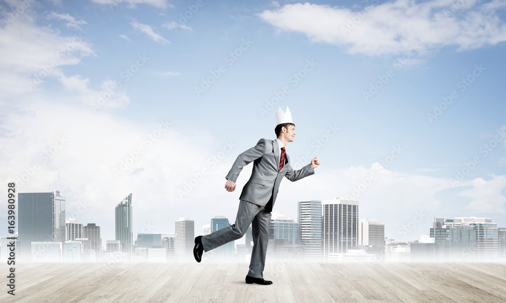 King businessman in elegant suit running and modern cityscape at background King businessman in elegant suit running and modern cityscape at background