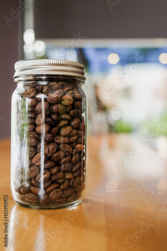Coffee beans in vintage glass on table