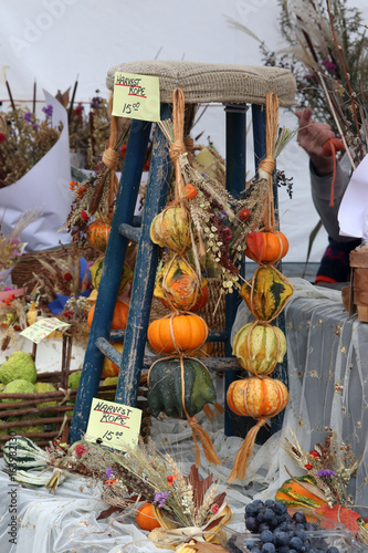 Farmers market goods display. Retail display for sale with beautiful autumn handmade seasonal decorations at the farmers market. Agriculture background. Harvest concept.