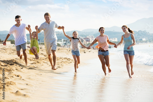 Big family running on beach