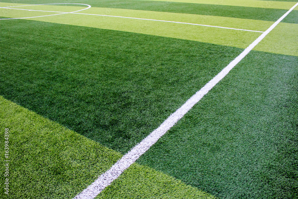 The white Line marking on the artificial green grass soccer field