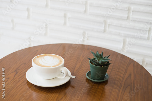 Fototapeta Naklejka Na Ścianę i Meble -  Latte art coffee on wooden table