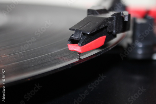 record player stylus arm on vinyl rotating disc background with copy space stock, photo, photograph, image, picture,