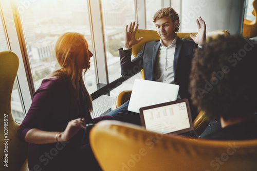 Bilde på lerret Young businessman with laptop is angry, annoyed, impatient and giving up during