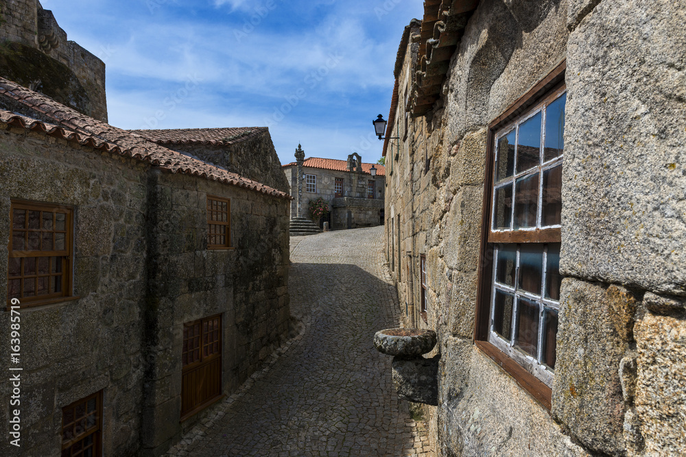 Narrow cobblestone street in the historic village of Sortelha in Portugal; Concept for travel in Portugal