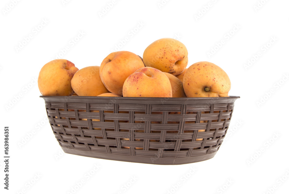 Apricot's in basket on white background