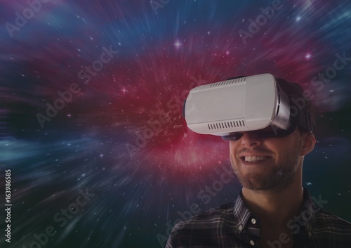 Man in VR headset smiling against galaxy background