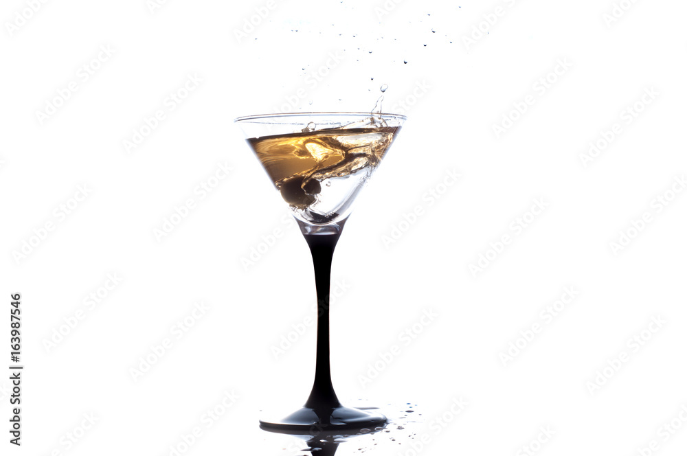 Cocktail martini with olive, a splash of vermouth in a glass Cocktail martini with olive, a splash of vermouth in a glass