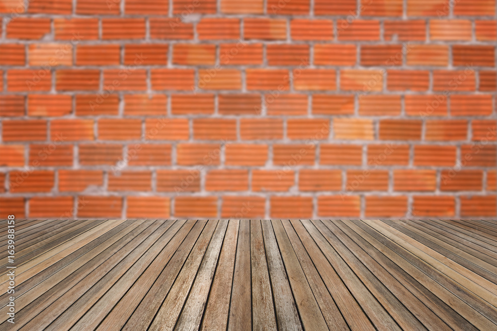 Wooden table on brick wall background