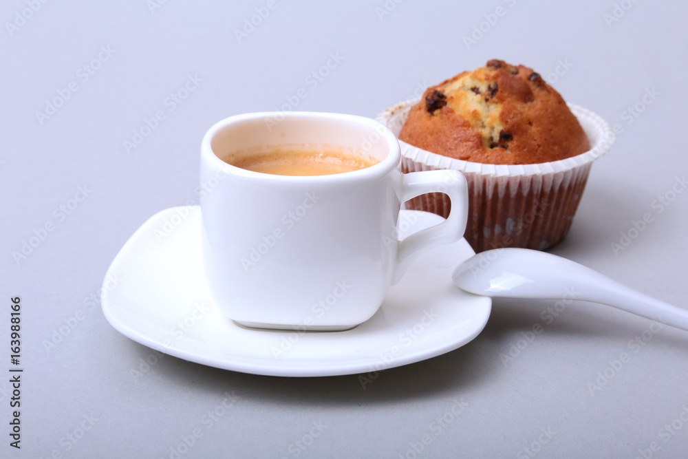 Classic espresso in white cup with homemade cake and chocolate on white background. Classic espresso in white cup with homemade cake and chocolate on white background.