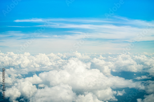 Aerial view of Blue sky and top Cloud view or cloudy of bird eye view from airplane window. © Pakkapol