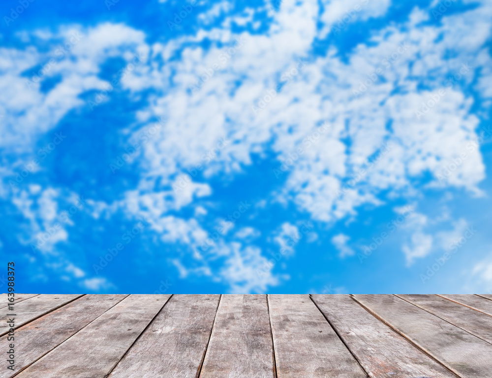 Wooden table with blue sky background