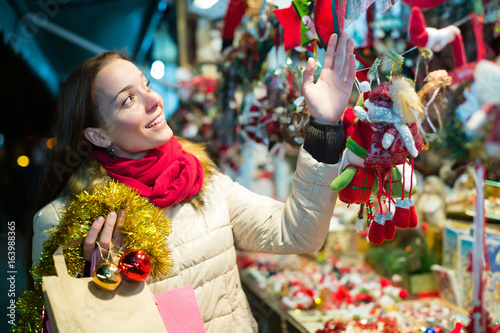 Woman at Christmas fair in evening.