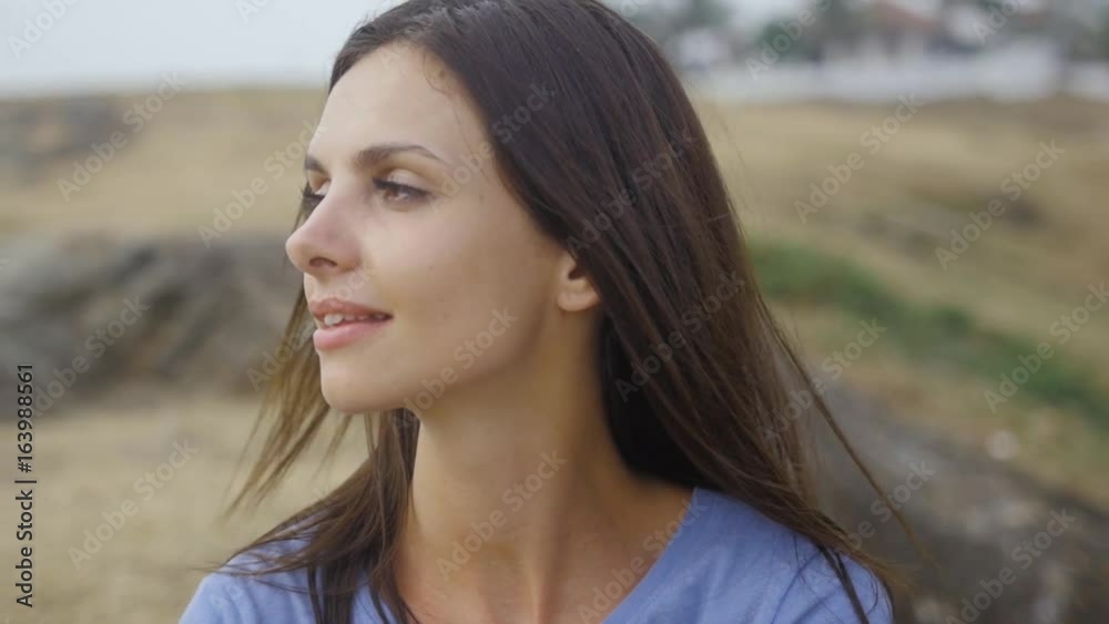 Close-up portrait of beautiful caucasian woman with charming smile walking outdoors Close-up portrait of beautiful caucasian woman with charming smile walking outdoors