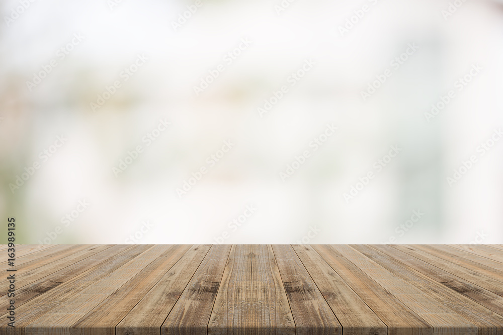 Wood table top on white blurred background from building,for montage your products Wood table top on white blurred background from building,for montage your products