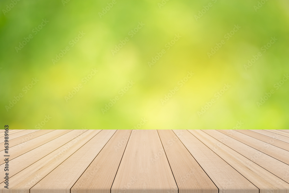 Wood table top on nature green blurred background,for montage your products Wood table top on nature green blurred background,for montage your products
