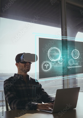 Happy man in VR headset looking at interface