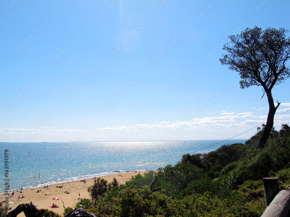 View of Sandringham beach at Melbourne, Australia. Have people walking, swimming and sunbathing round of coast.