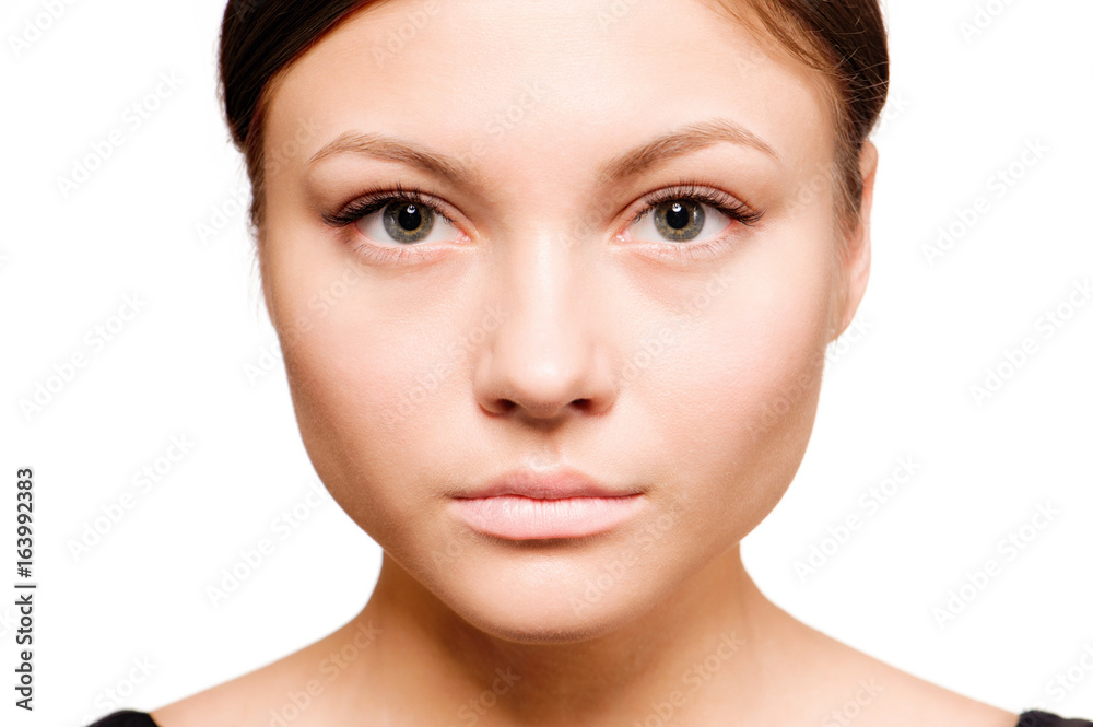 Beautiful woman face close up studio on white Beautiful woman face close up studio on white
