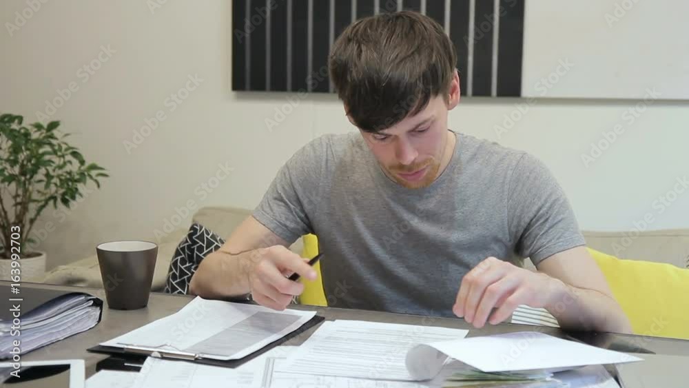Chief architect examines estimate documentation sitting in office indoors