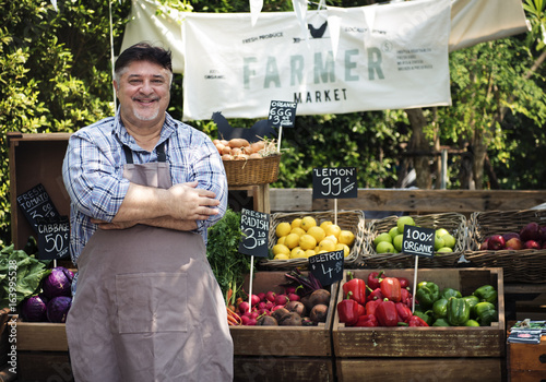 Photos Greengrocer selling organic fresh agricultural product at farmer market